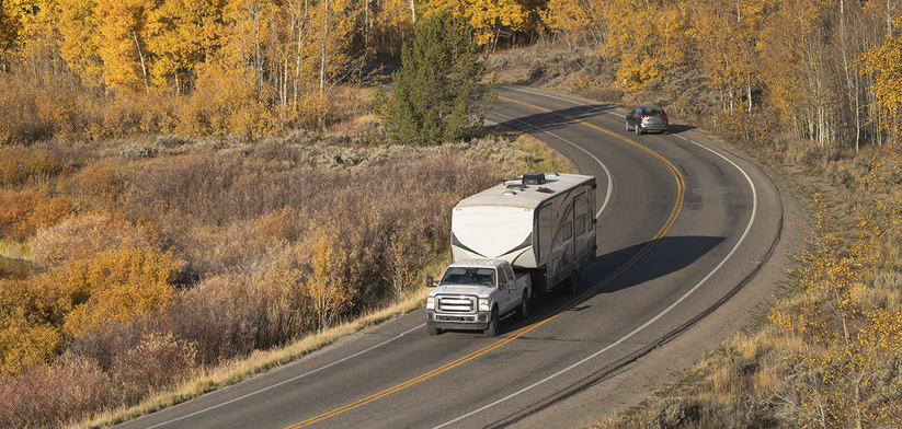 RV on U.S. Highway along the bend of a river during fall