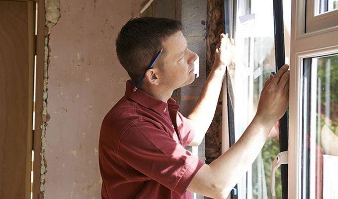 man installing window