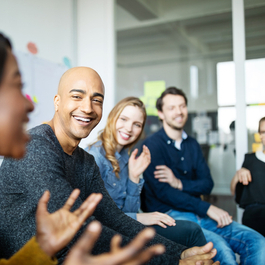 Co-workers sitting around a circle in a group discussion.