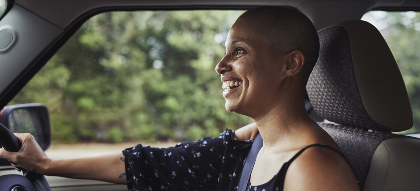 Portrait of laughing woman in car.