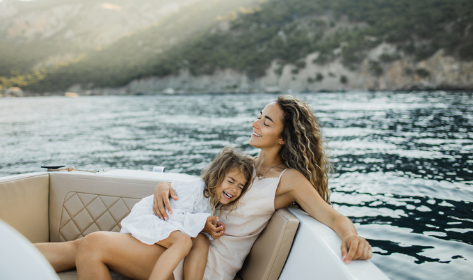 Mother daughter laughing on a boat