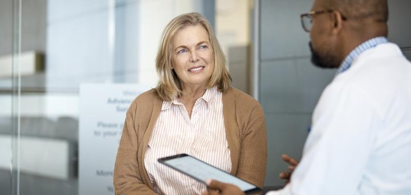 doctor consulting patient in person with a tablet 